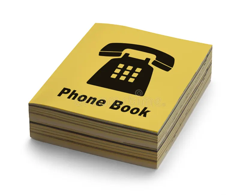 open phone book with a landline phone handset sitting on top